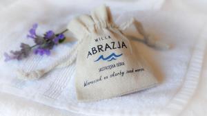 a napkin with a tag on top of a towel at Willa Abrazja in Jastrzębia Góra