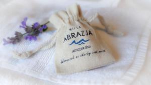 a napkin with a tag on top of a towel at Willa Abrazja - wypoczynek dla dorosłych in Jastrzębia Góra