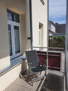 a chair sitting on the balcony of a house at De Strandloper in Garz-Rügen