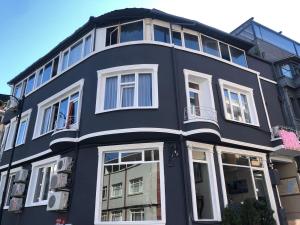 a large black building with white windows at Bahaus Guesthouse Hostel in Istanbul