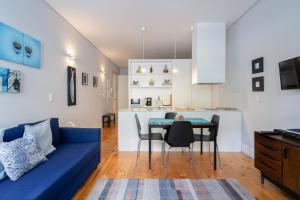 a living room with a blue couch and a table at OPO Downtown Blue in Porto