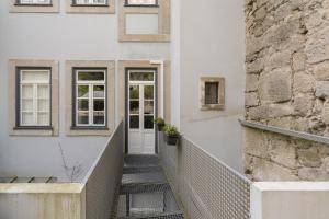 a stairway leading to a white building with a door at OPO Downtown Blue in Porto