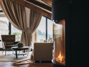 a living room filled with furniture and a fire place at VAYA Fieberbrunn in Fieberbrunn