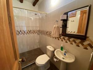 a small bathroom with a toilet and a sink at Kasazha- Casa entera en Barichara 3 habitaciones. in Barichara