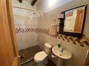 a small bathroom with a toilet and a sink at Kasazha- Casa entera en Barichara 3 habitaciones. in Barichara +70 photos