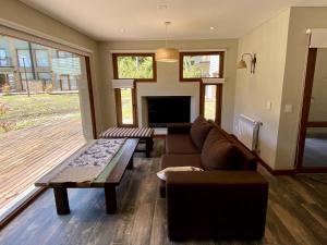 a living room with a couch and a table at Altos del Bonito in Villa La Angostura