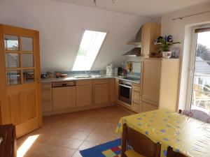 a kitchen with a table and a sink and a table and a window at Ferienwohnung Aschka in Schönsee