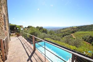 a balcony with a view of a swimming pool at Casa Mela in Vinci