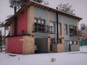 a house with a garage in the snow at Altos del Bonito in Villa La Angostura