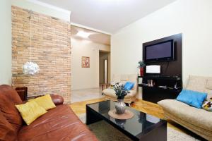 a living room with a couch and a tv at Centr kvartir 5 in Minsk
