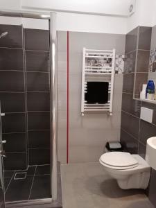 a bathroom with a toilet and a sink at Apartament Porto Del Mar in Mamaia Sat/Năvodari