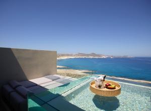 a swimming pool with a view of the ocean at Domes White Coast Milos, Adults Only - Small Luxury Hotels of the World in Mytakas