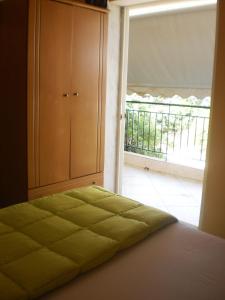 a bedroom with a bed and a large window at Zavrakli in Agia Paraskevi