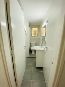 a bathroom with a toilet and a sink at Simple One bedroom flat in Engomi in İncirli +9 photos