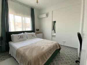 a bedroom with a bed with two pillows on it at Simple One bedroom flat in Engomi in İncirli