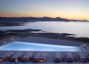 a swimming pool with a view of the ocean at Domes White Coast Milos, Adults Only - Small Luxury Hotels of the World in Mytakas