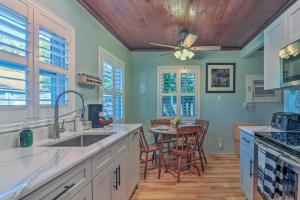a kitchen with a table and a ceiling fan at Quiet Crystal Beach Hideaway - Steps to the Sand! in Crystal Beach