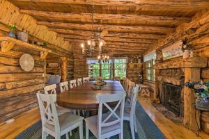 a dining room with a table and chairs and a fireplace at Secluded Cabin with Spacious Kitchen and Dining Area! in Sunset