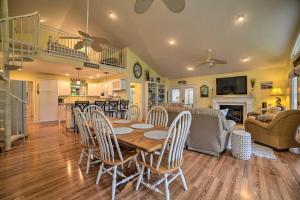 a dining room and living room with a table and chairs at Kentucky Lake House with a Great Outdoor Space! in Gilbertsville