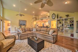 a living room with two couches and a table at Kentucky Lake House with a Great Outdoor Space! in Gilbertsville