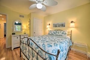 a bedroom with a bed and a ceiling fan at Kentucky Lake House with a Great Outdoor Space! in Gilbertsville