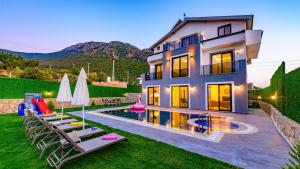 a villa with a swimming pool and a house at Atlantis - 4 Bedroom Holiday Villa in Hisaronu in Oludeniz