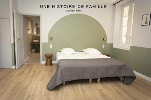 A bed or beds in a room at UNE HISTOIRE DE FAMILLE