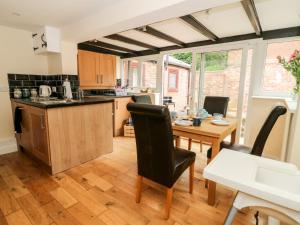 a kitchen and dining room with a table and chairs at Claire Cottage in Selby