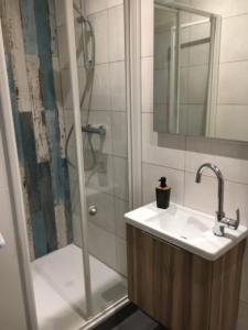 a bathroom with a sink and a shower at Bright Apartment In The Center Of La Baule in La Baule