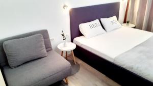 a small bedroom with a bed and a chair at Ani 2 in Gradac