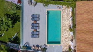 an overhead view of a house with a swimming pool at Tramonto Villa in Volímai