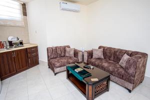 a living room with a couch and a coffee table at Al Riyati Hotel Apartments in Aqaba