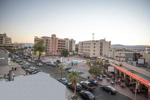 a city with cars parked in a parking lot at Al Riyati Hotel Apartments in Aqaba