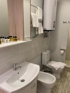 a bathroom with a white sink and a toilet at Hotel Vokrug Sveta in Adler