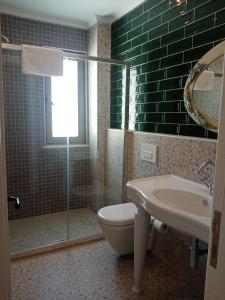 a bathroom with a toilet and a sink and a shower at Dolphin Park Hotel in Ortaca