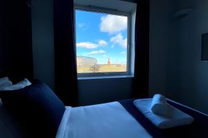 a bedroom with a bed and a window with a view at Middlehaven Apartment in Middlesbrough