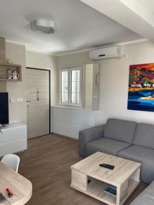a living room with a couch and a coffee table at Apartment AndjelaS in Tivat