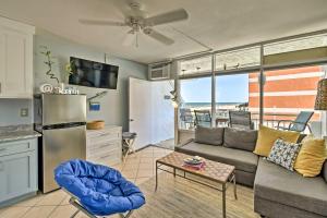 a living room with a couch and a table at Oceanfront Resort Studio on Virginia Beach! in Virginia Beach