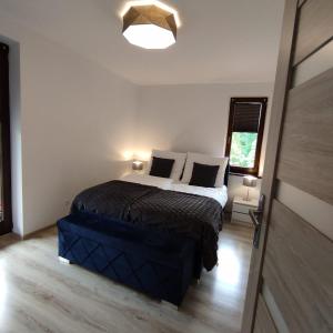 a bedroom with a large bed in a room at Apartament Szumi Las Kletno in Kletno