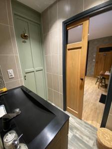 a kitchen with a black counter top and a door at Céline et Olivier in Pornic