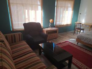 a living room with a couch and a chair at LA PITA BEACH HOUSE in Almería