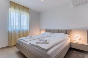 Posteľ alebo postele v izbe v ubytovaní Villa Orhideja