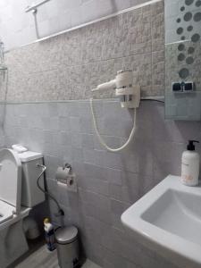 a bathroom with a toilet and a sink in it at Al-marsa2 in Al Hoceïma