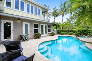 a swimming pool in the backyard of a house at Coquina Sands in Holmes Beach