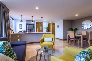 a living room with a couch and chairs and a table at Alcazar de Oviedo by EE Hoteles in Medellín