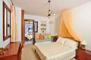 a bedroom with a bed and a living room at Lindian Jewel Exclusive Apartments in Líndos