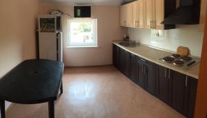 a kitchen with a refrigerator and a chair in it at House in Karolino-Buhaz in Zatoka