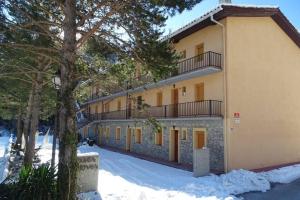 a building with snow on the ground in front of it at Apartamento rural en Los Pirineos in Guardiola de Berguedà