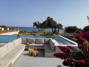 a living room with a couch and a swimming pool at Villa Del Nonno in Lardos