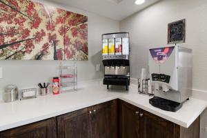 a kitchen with a counter with a coffee machine at Red Roof Inn PLUS + Galveston - Beachfront in Galveston